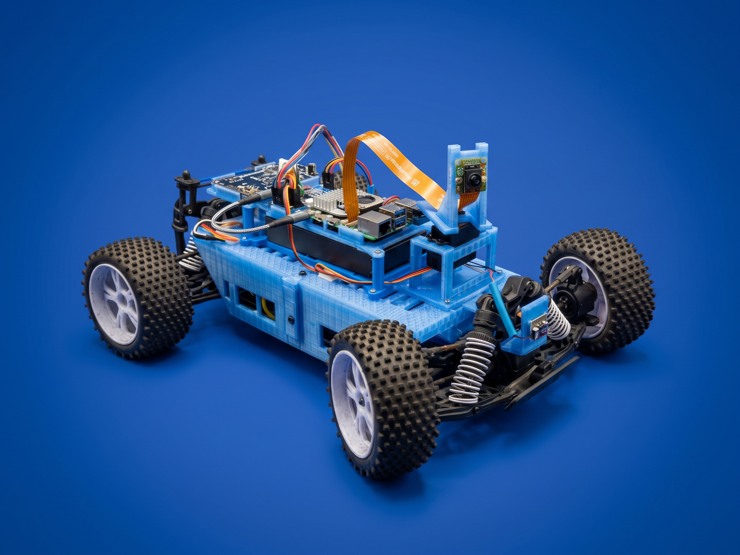 Grok Bot rover with a blue printed chassis, Raspberry Pi, raised camera and four off-road wheels